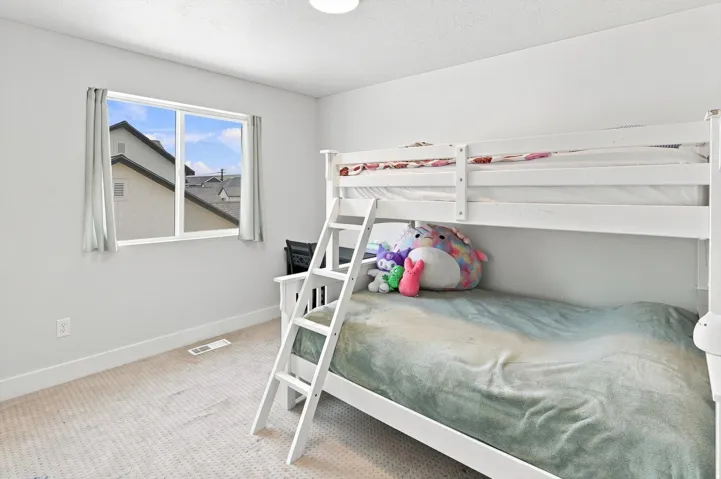 Room with light-colored carpeting, white walls, and a single window