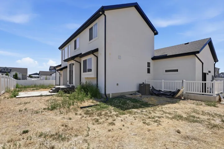Modern two-story residence featuring a clean, contemporary exterior with neutral-toned siding and dark trim accents