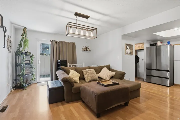 Open concept living area with access to private patio through sliding door and spiral staircase taking you down to the basement.