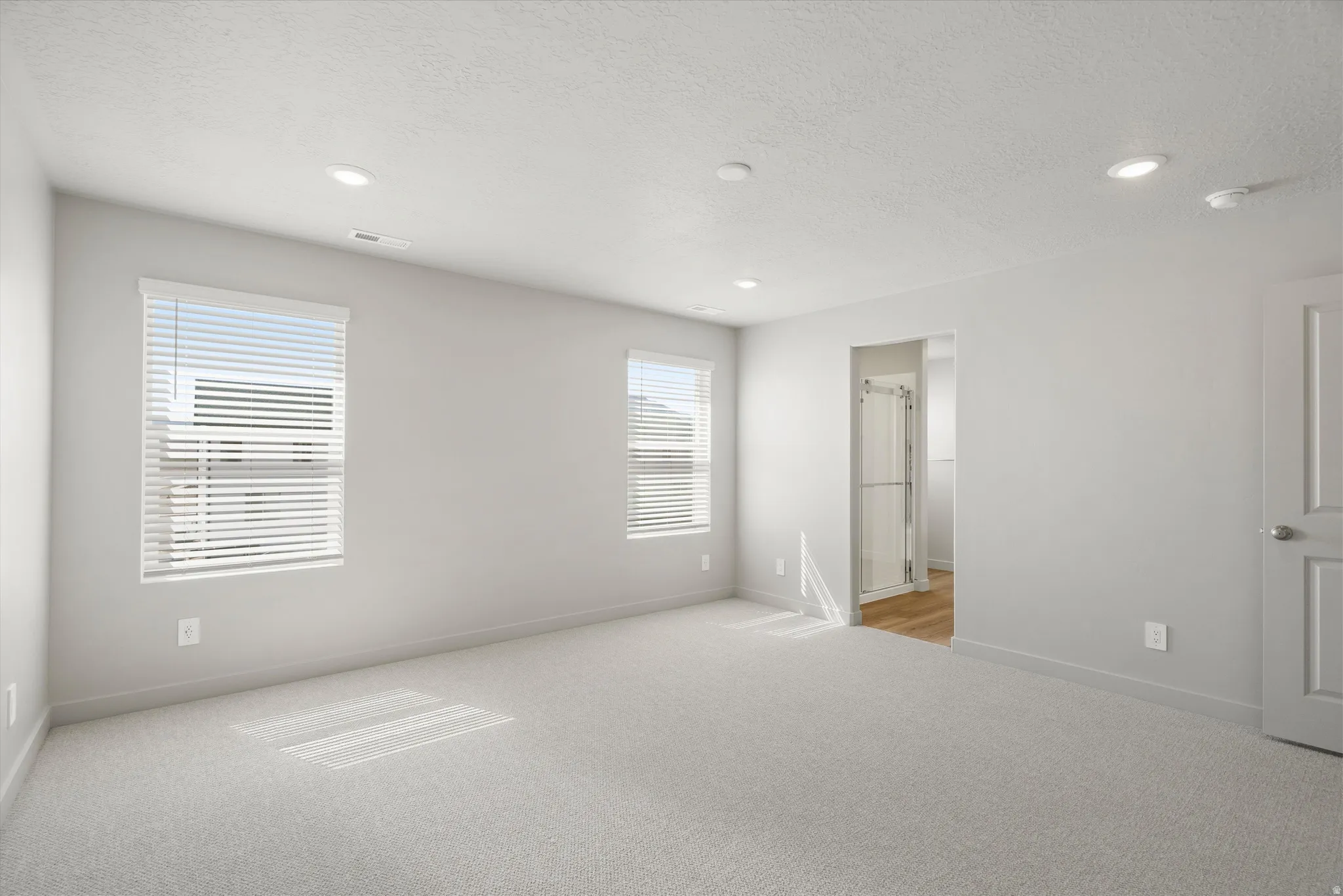 **DISCLAIMER** Interior package may vary. Recessed lighting, light gray wall finishes, light carpeting, white trim work, and a white interior door