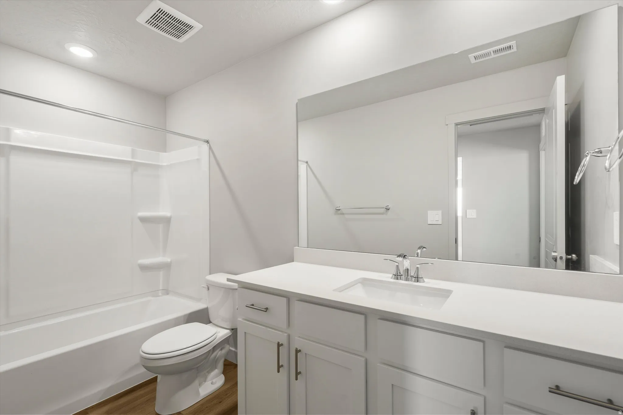 **DISCLAIMER** Interior package may vary. Bathroom with a white vanity featuring a rectangular under-mount sink, chrome faucet, and expansive mirror