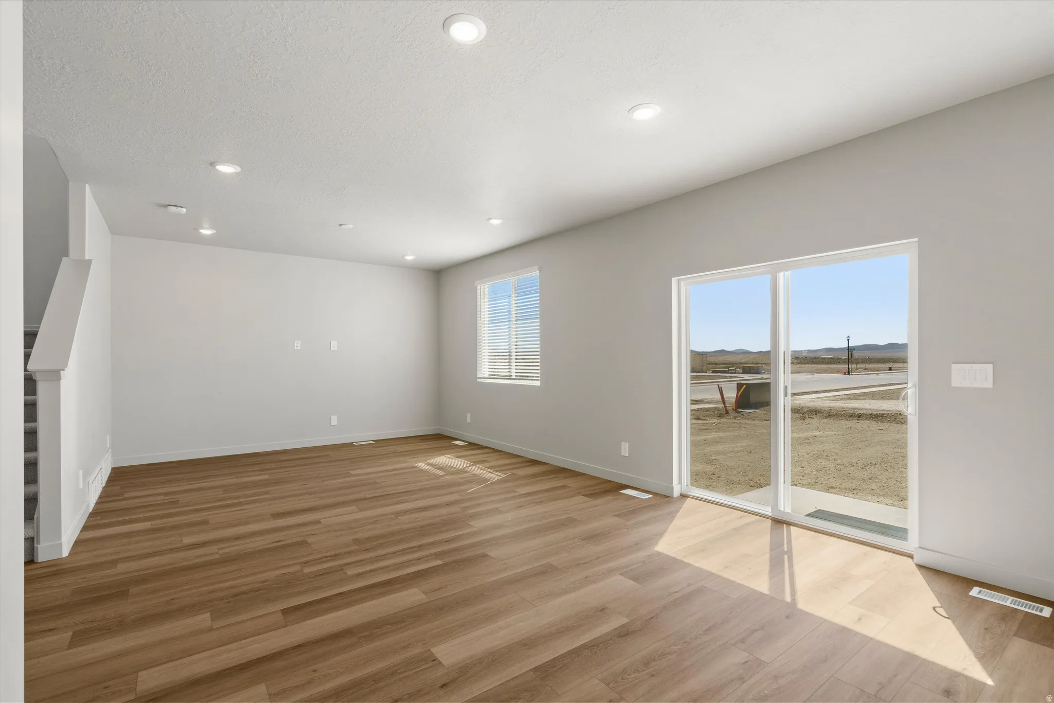 **DISCLAIMER** Interior package may vary. Wood-finish flooring, recessed lighting, and a window with blinds