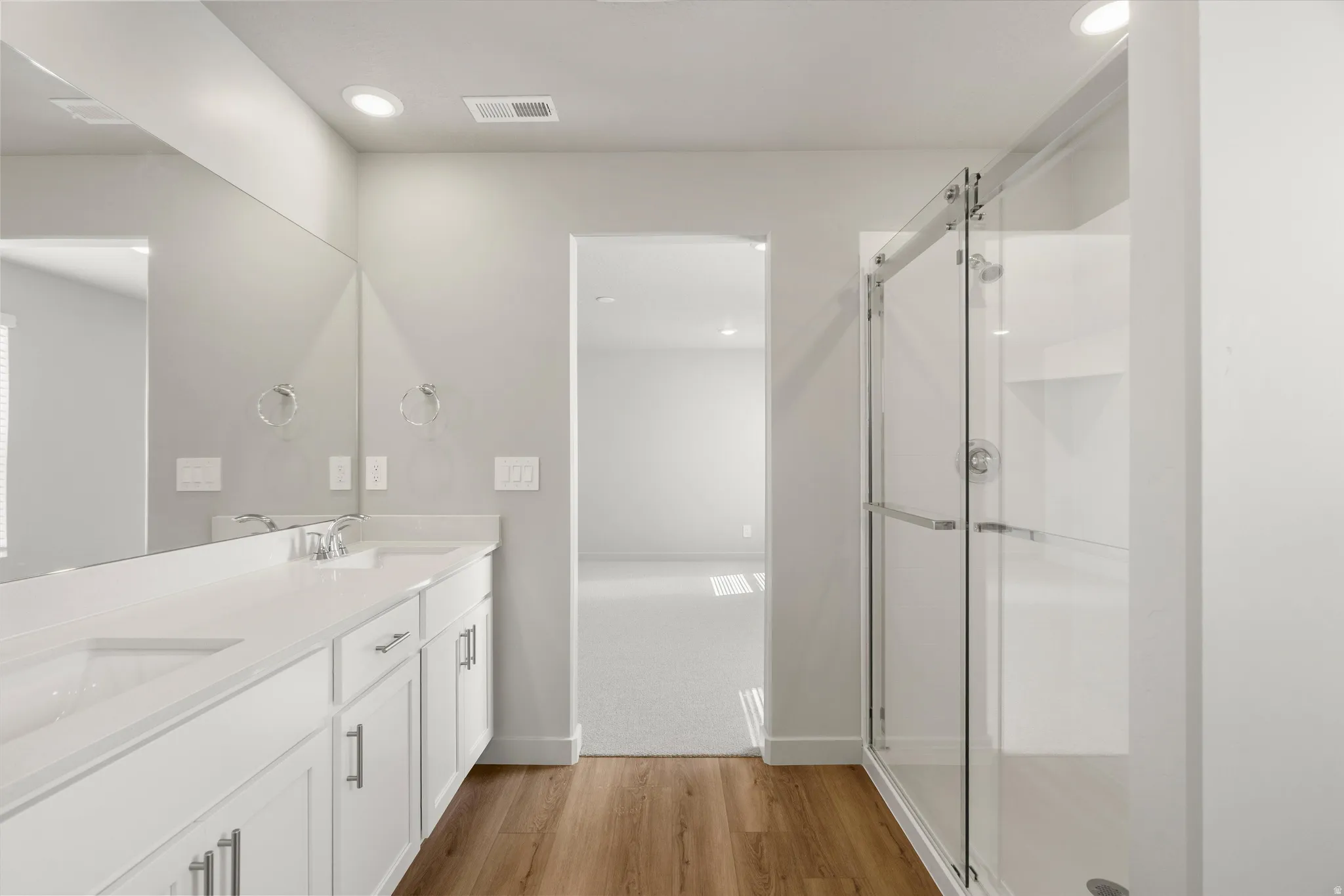 **DISCLAIMER** Interior package may vary. Dual vanity with white cabinetry, integrated sinks, and polished chrome fixtures
