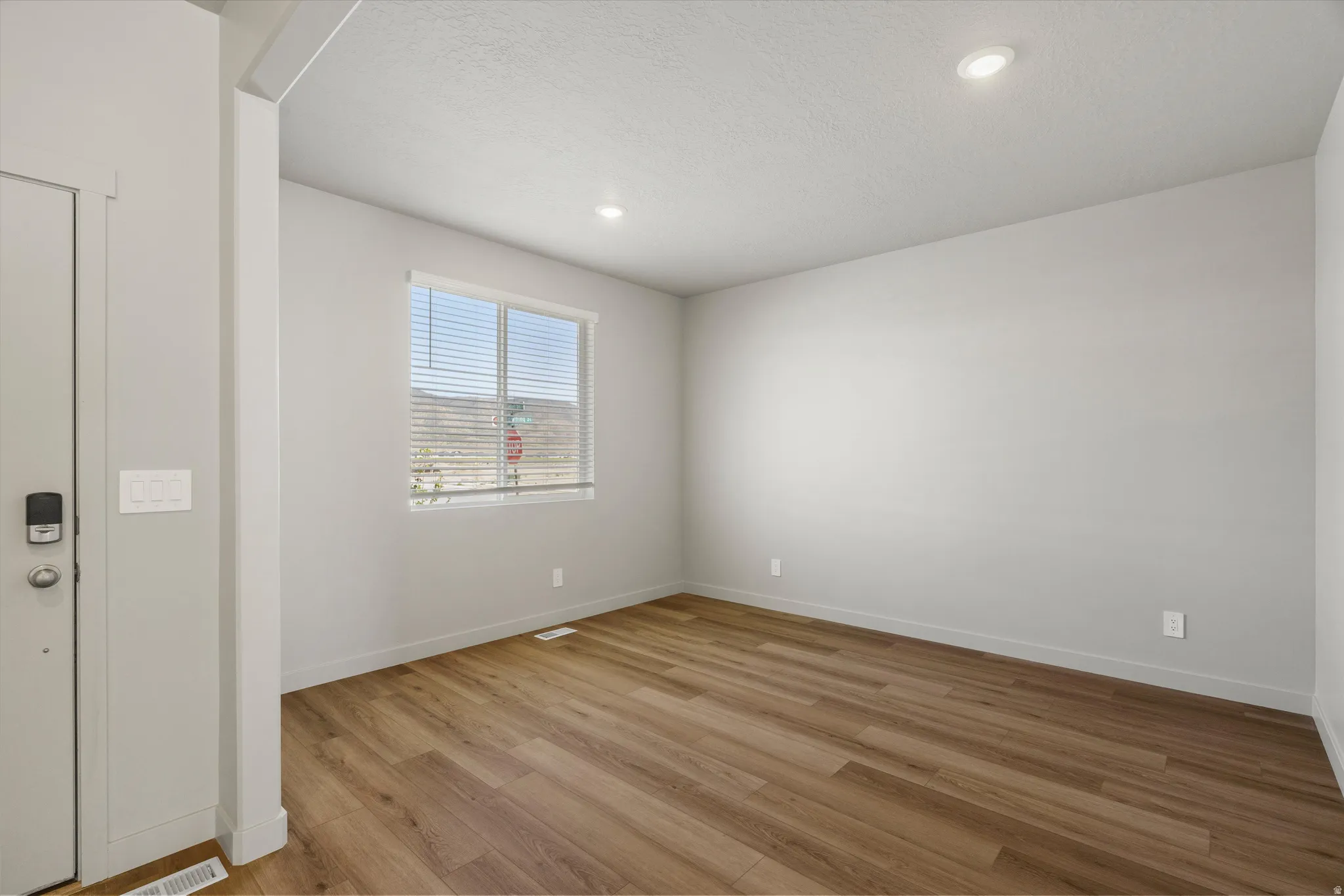 **DISCLAIMER** Interior package may vary. Recessed ceiling lighting, wood-finish flooring, and a large window with blinds