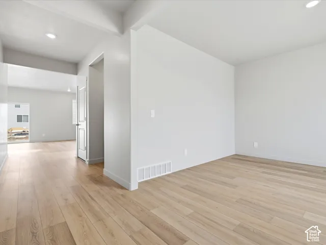 Neutral-toned interior featuring wood-finish flooring, recessed lighting, and crisp white wall paint