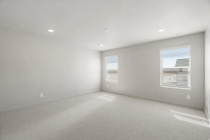 **DISCLAIMER** Interior package may vary. Neutral tone walls, recessed lighting, two windows with blinds, and light-toned carpeting