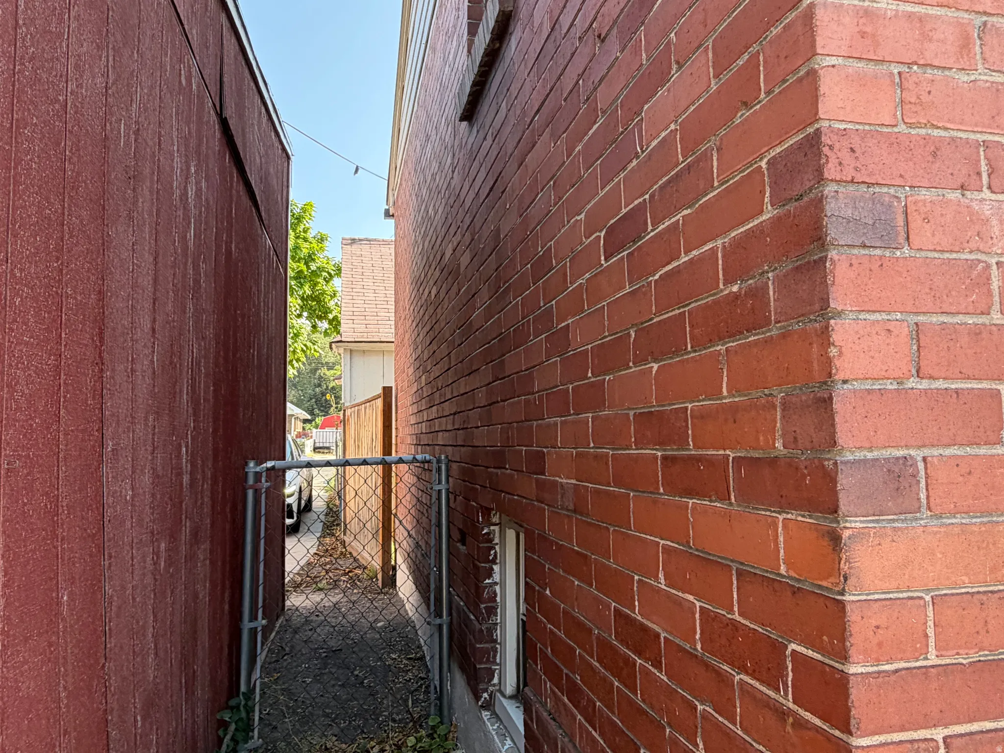 Red brick exterior wall with a small window