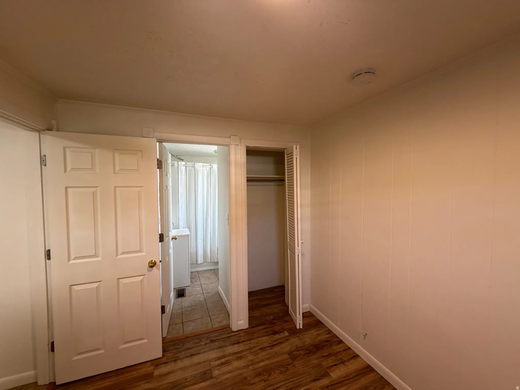 Wood-finish flooring with white paneled walls