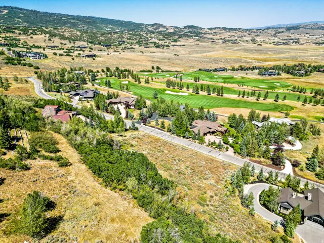 Expansive undeveloped land with a distant golf course
