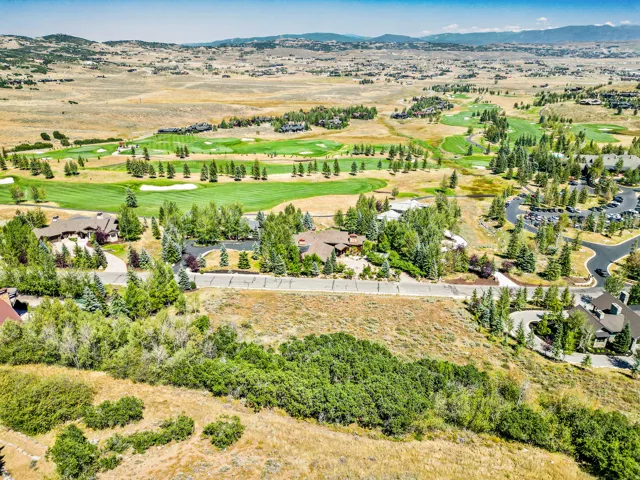 Aerial view showcasing a distinctive residential compound set within rolling terrain