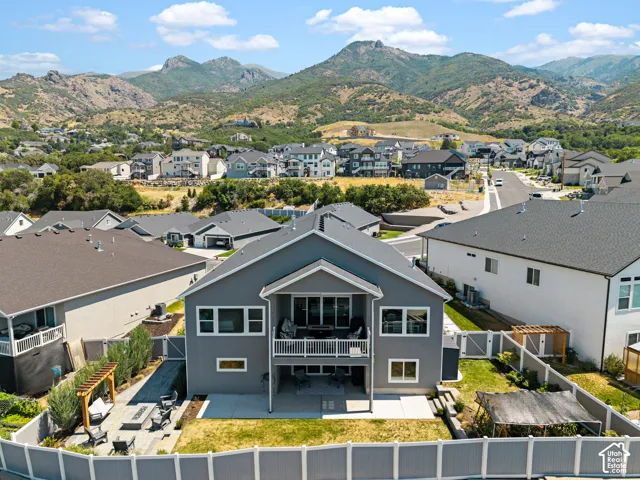 Contemporary gray exterior with a second-story balcony and ground-level patio