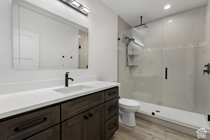 Bathroom featuring a dark wood-finish vanity with a white countertop and rectangular sink