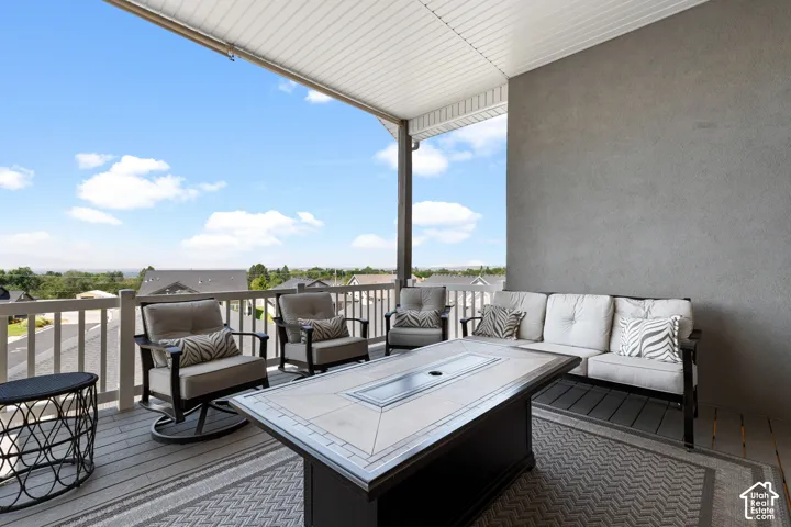 Covered outdoor patio featuring a textured wall, a white slatted ceiling, and a railing system