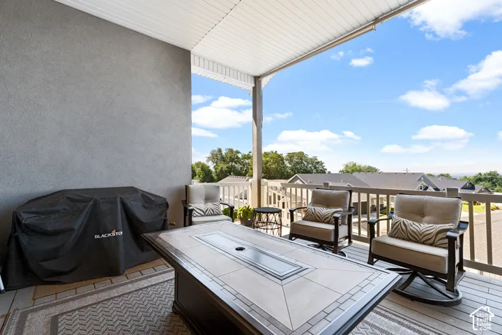 Covered outdoor patio featuring composite decking and a textured stucco wall