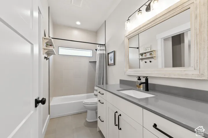 Bathroom featuring a white vanity with a rectangular undermount sink, gray countertop, and matte black faucet