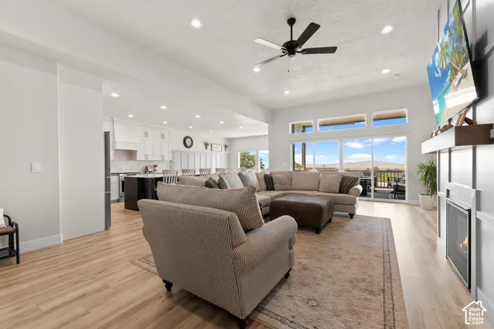 Open-concept living space featuring wood-finish flooring, recessed lighting, and a modern ceiling fan