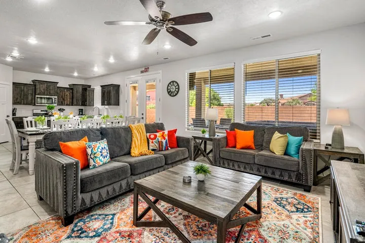 Open-concept living space featuring recessed lighting, a ceiling fan, and large windows with blinds