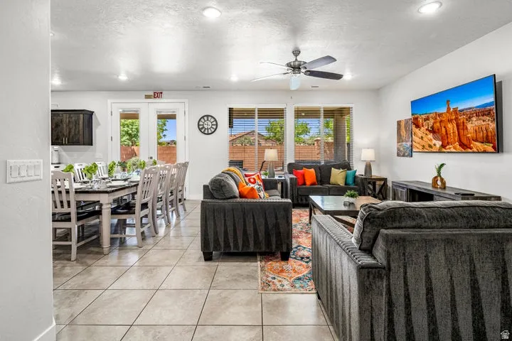 Open-concept living area with tile flooring and recessed lighting