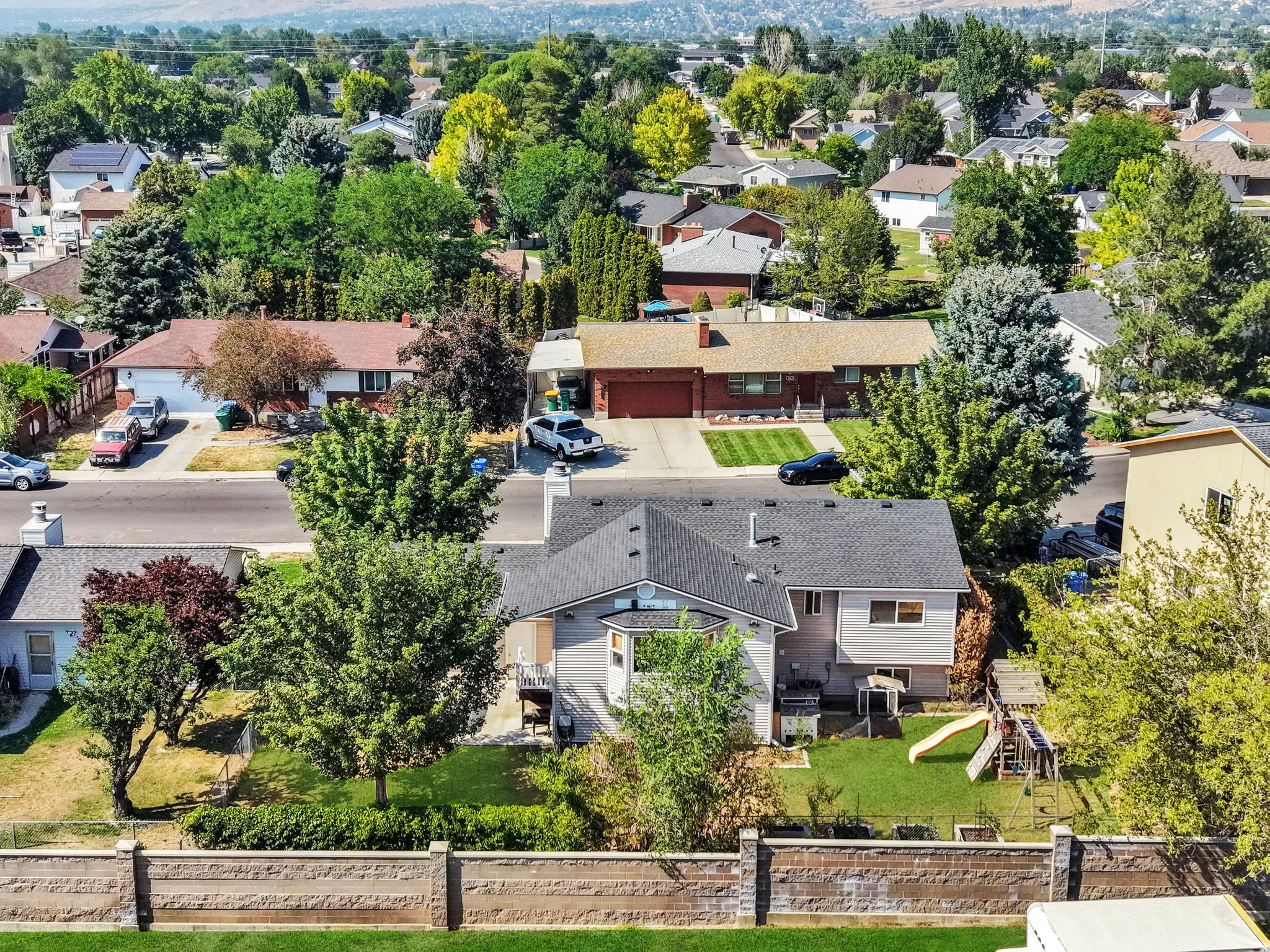 Charming single-story residence set on a generous lot featuring mature landscaping, manicured lawn, and established trees throughout the property