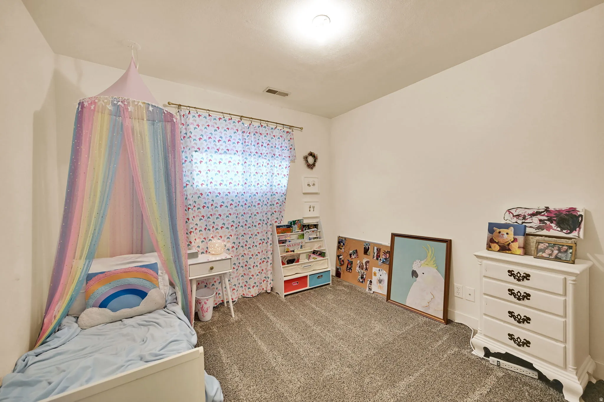 Neutral wall paint, carpet flooring, a window with curtain rod, and an overhead light fixture