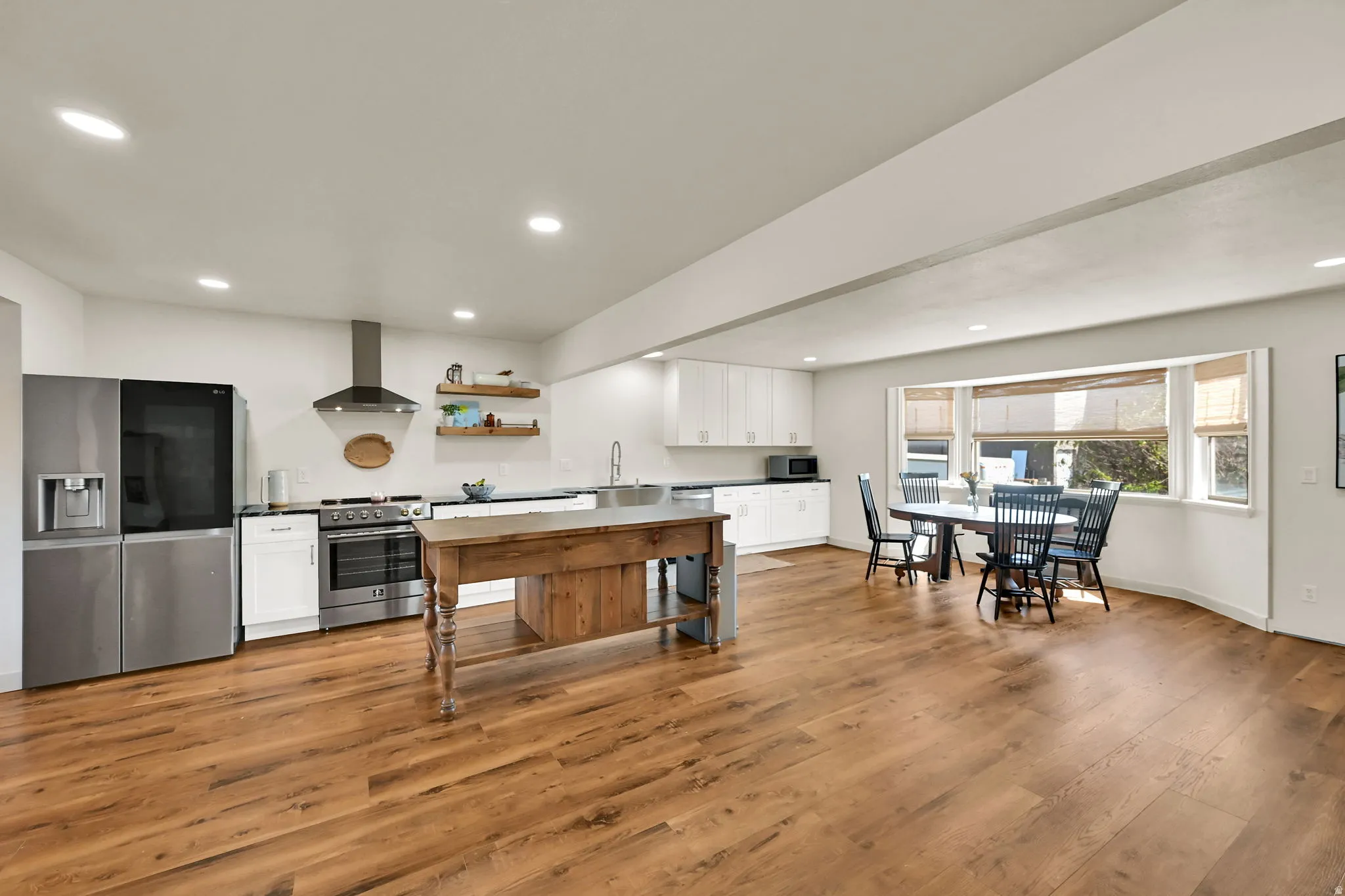 Expansive wood-finish flooring throughout, complemented by recessed lighting