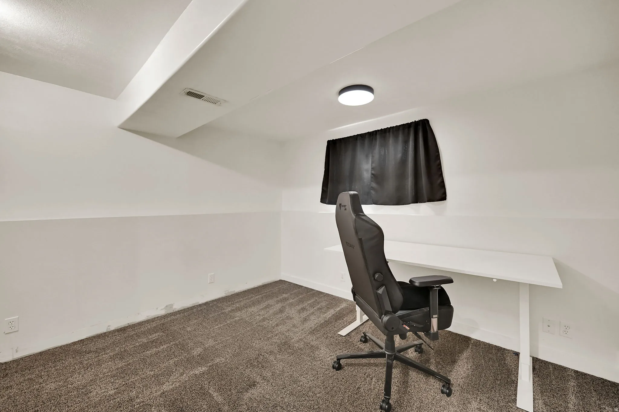 Recessed ceiling vent, flush-mount ceiling light fixture, and textured carpet flooring