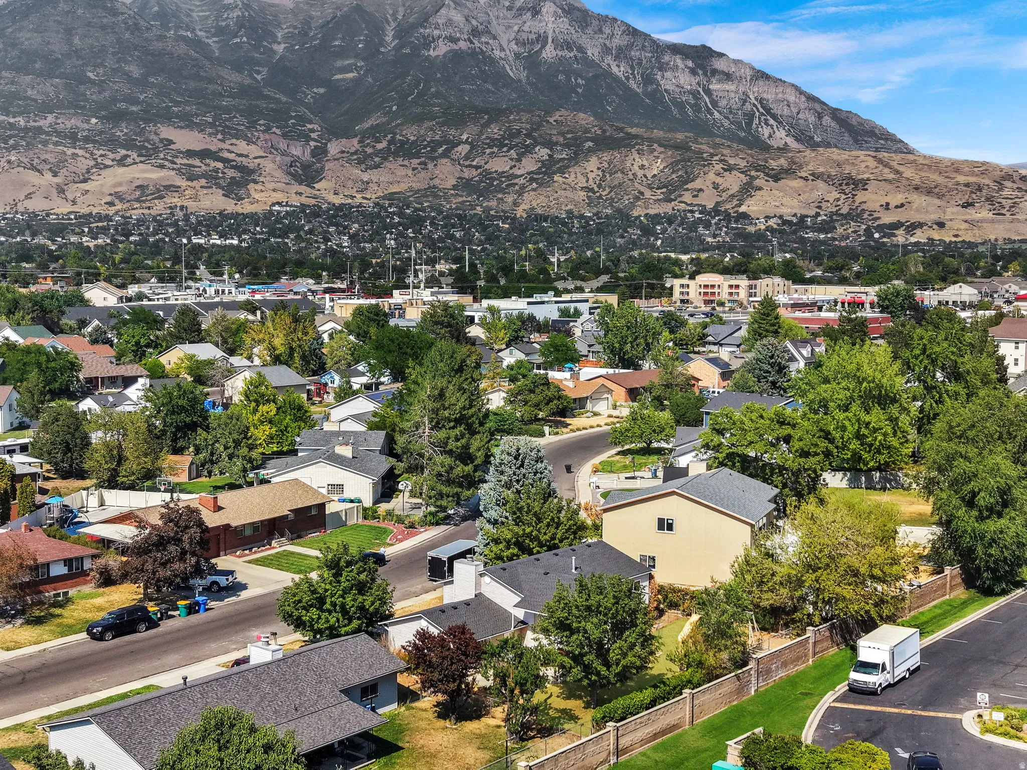 Scenic residential neighborhood nestled beneath dramatic mountain backdrop
