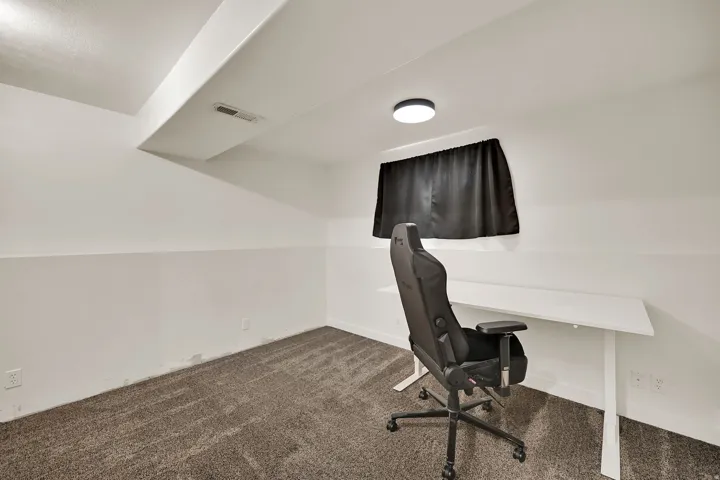 Recessed ceiling vent, flush-mount ceiling light fixture, and textured carpet flooring