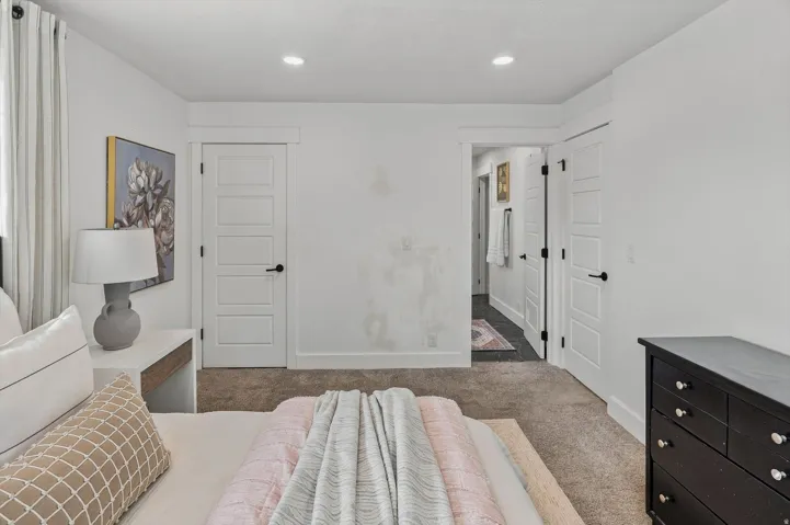 Recessed lighting, white walls, and neutral carpet flooring