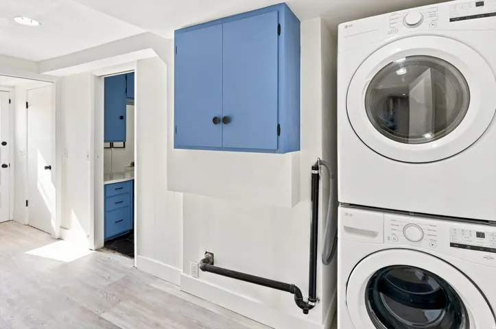 Built-in blue cabinetry, wood-finish flooring, and white walls