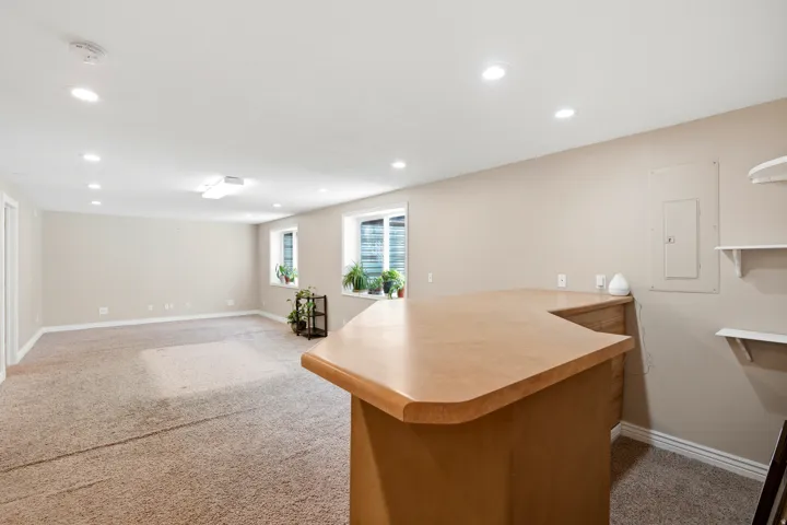 Spacious lower-level room featuring carpeted flooring and recessed lighting