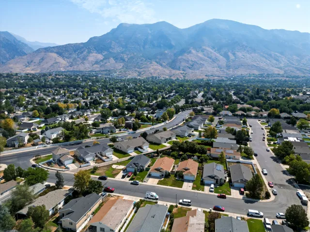 Aerial perspective showcasing a well-appointed residential community nestled against dramatic mountain backdrop