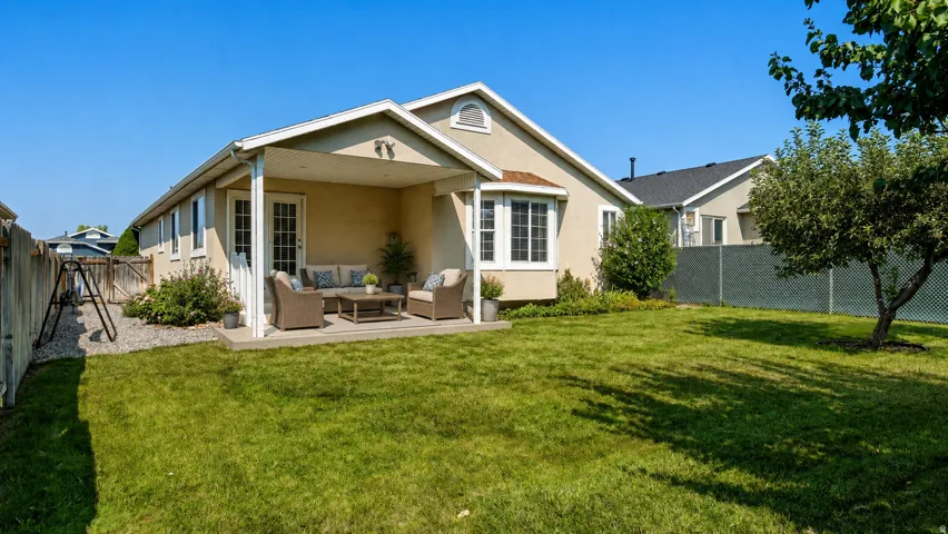 Charming single-story residence with a covered front porch featuring white columns and gable detailing