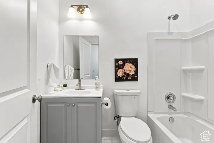 Bathroom featuring a vanity with a white countertop, undermount sink, and brushed nickel faucet