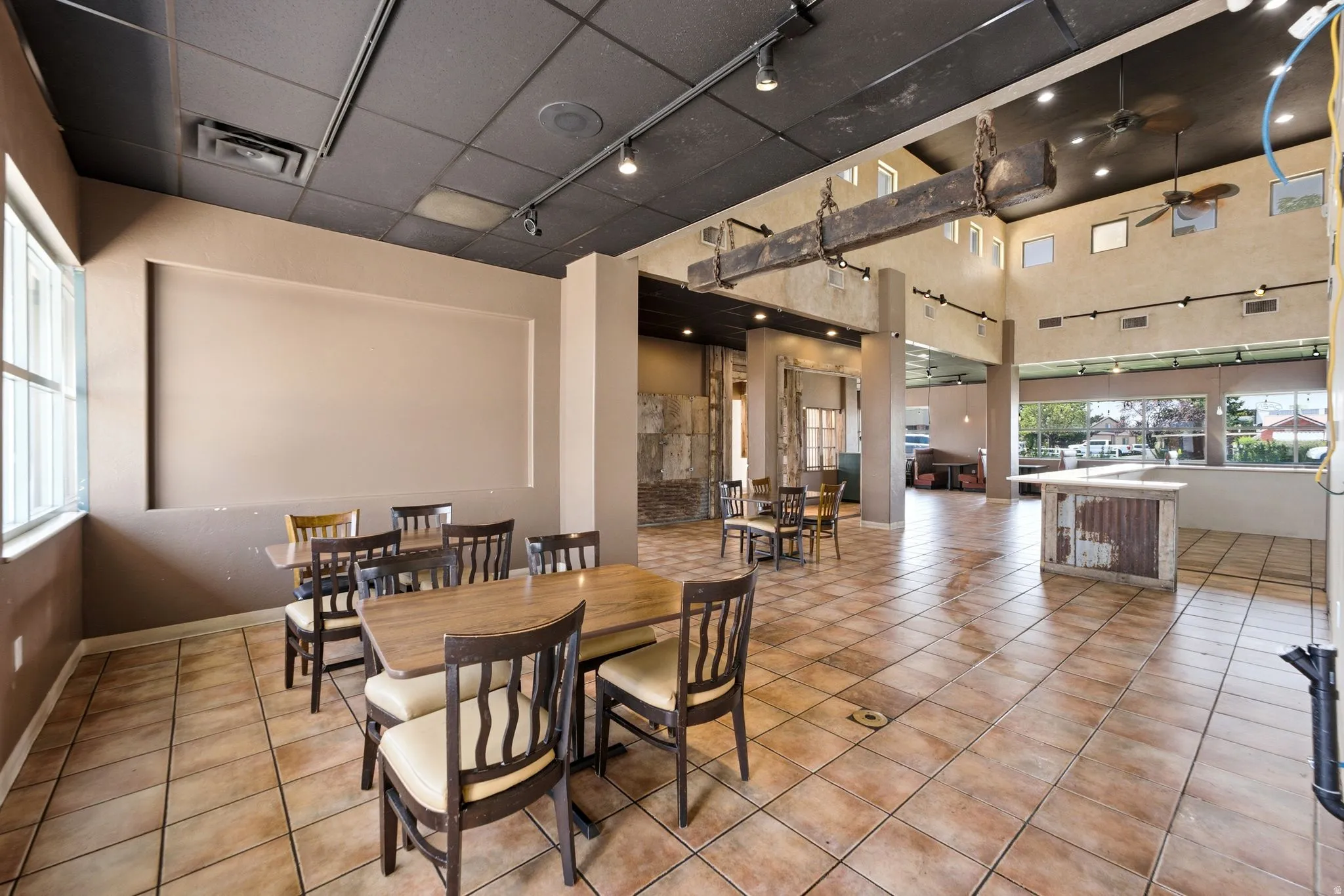 Spacious interior featuring tile flooring, track lighting, and high ceilings with clerestory windows