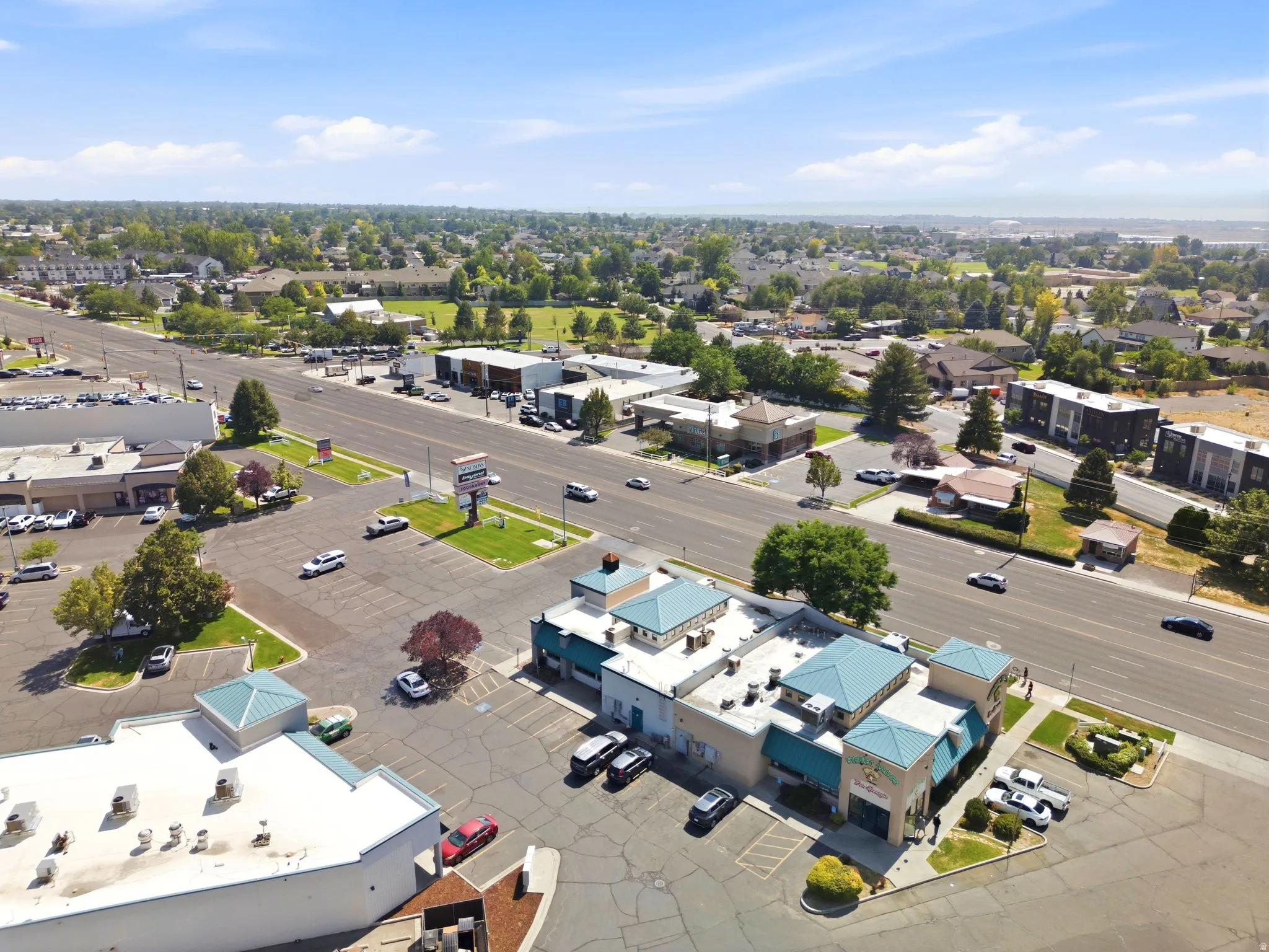 Commercial building with a prominent street presence and extensive paved parking
