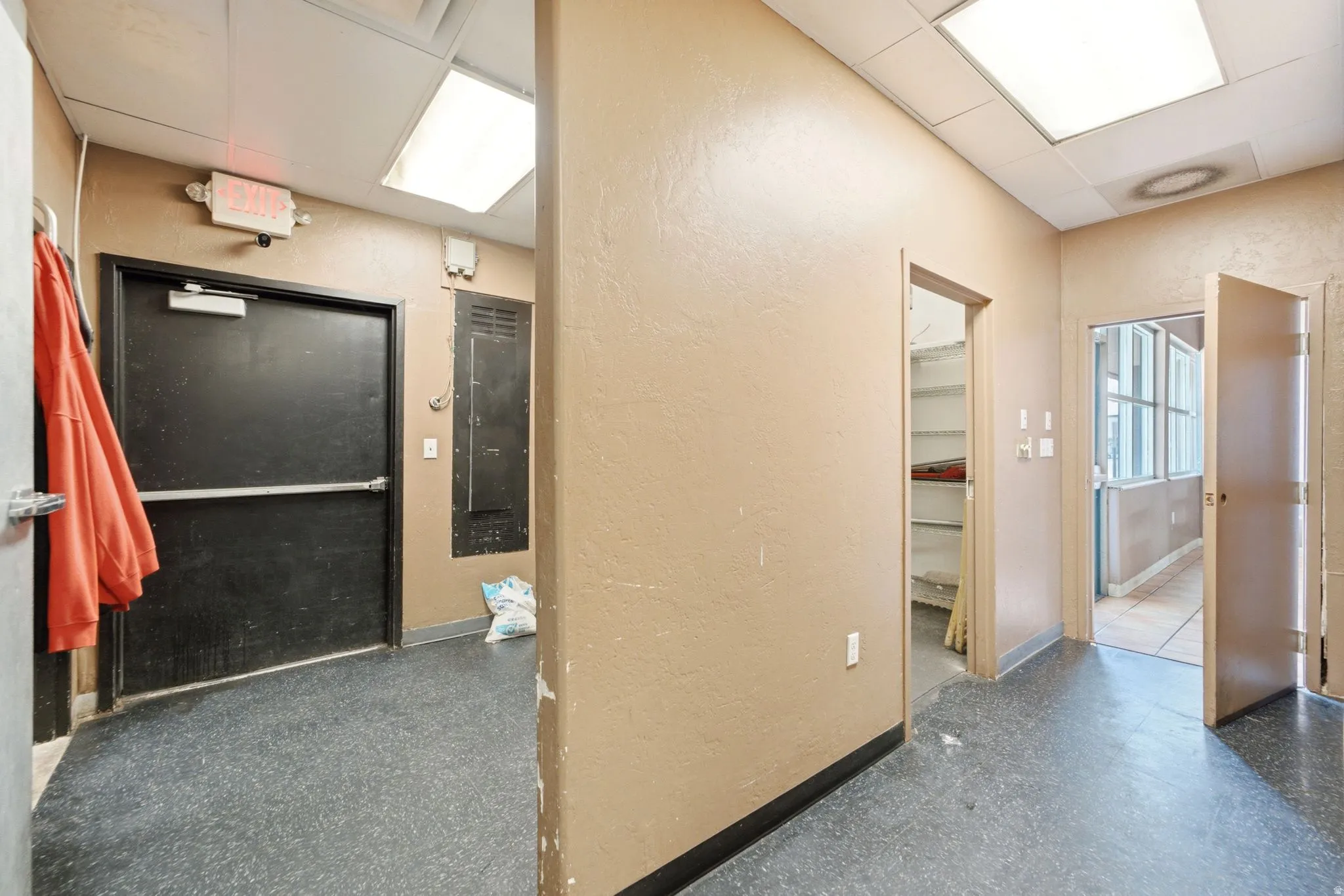 Hallway to dry storage/utility room and doorway to dining area. Hallway can serve as extra dry storage with shelving.