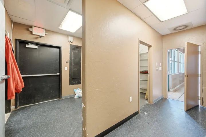 Hallway to dry storage/utility room and doorway to dining area. Hallway can serve as extra dry storage with shelving.