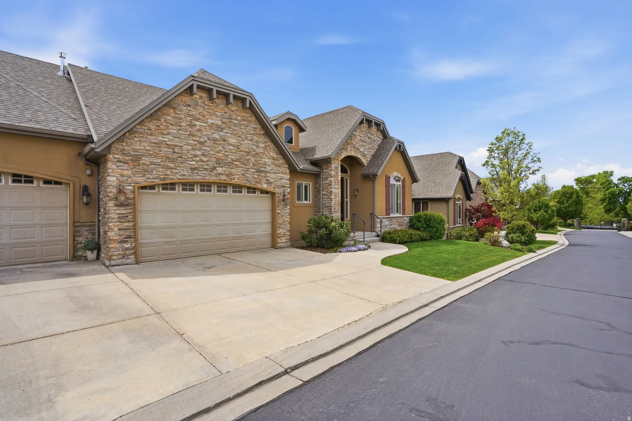 Elegant brick and stone exterior with multiple gabled rooflines and architectural detail