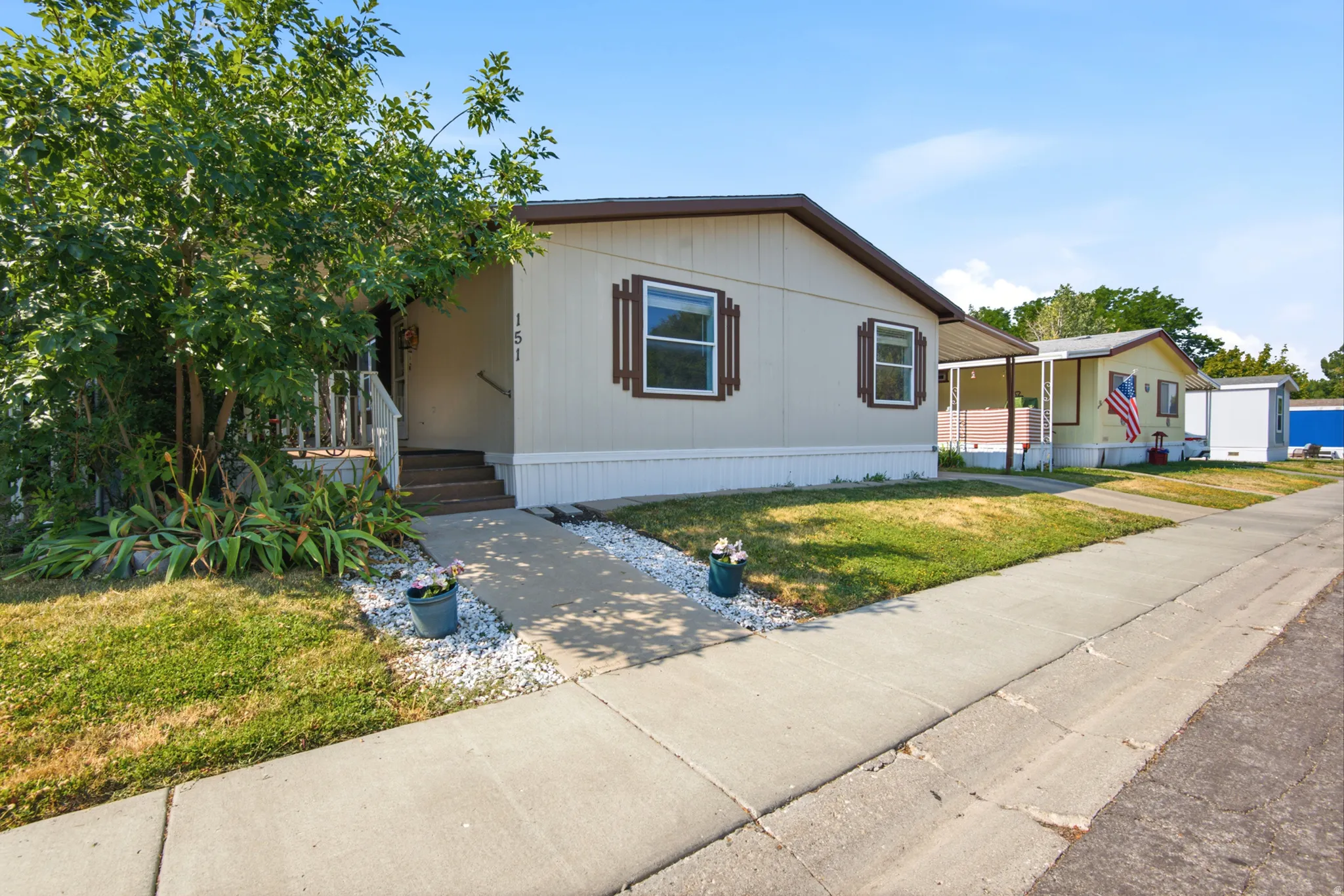 Light-colored exterior siding with contrasting brown trim