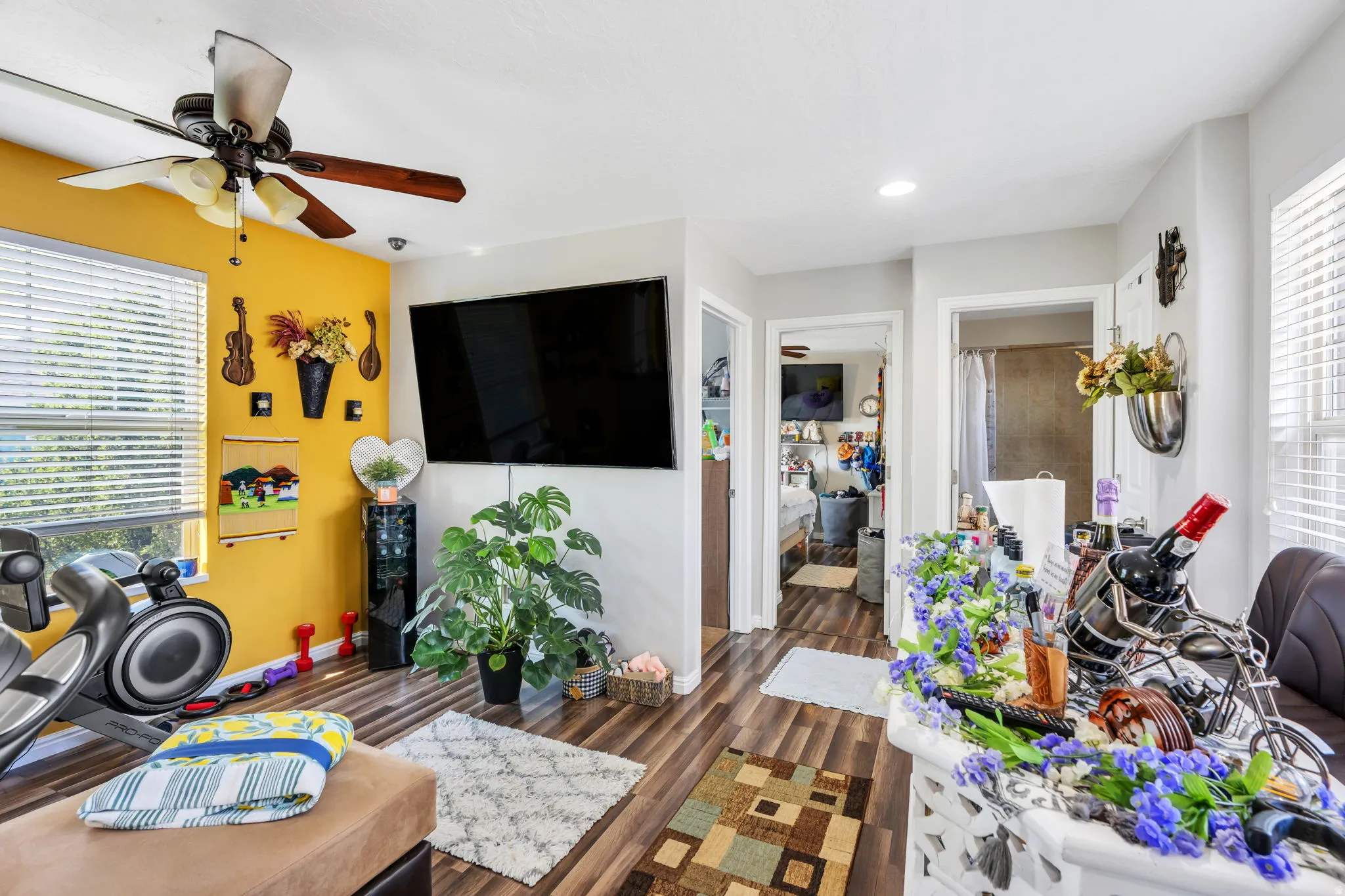 Recessed lighting, wood-finish flooring, ceiling fan, and window with horizontal blinds