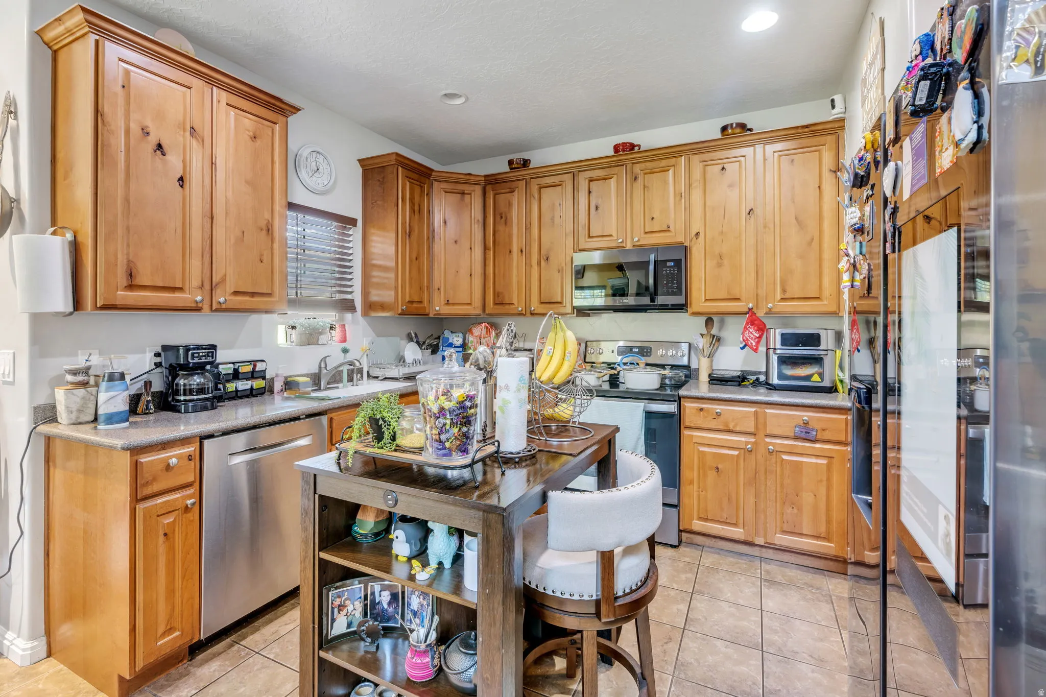Wood-finish cabinetry paired with stainless steel appliances
