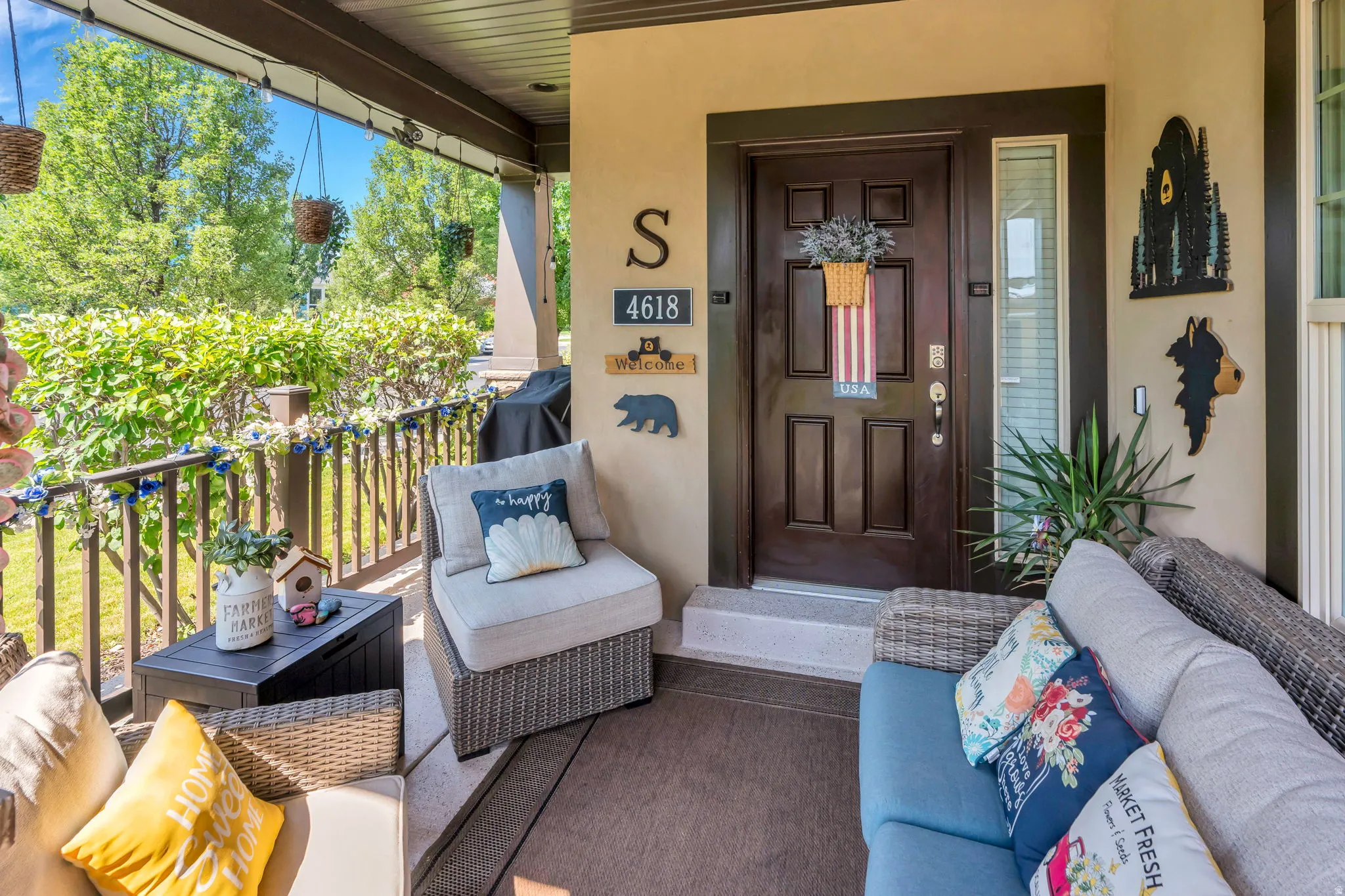Covered front porch featuring a dark wood paneled door and side light