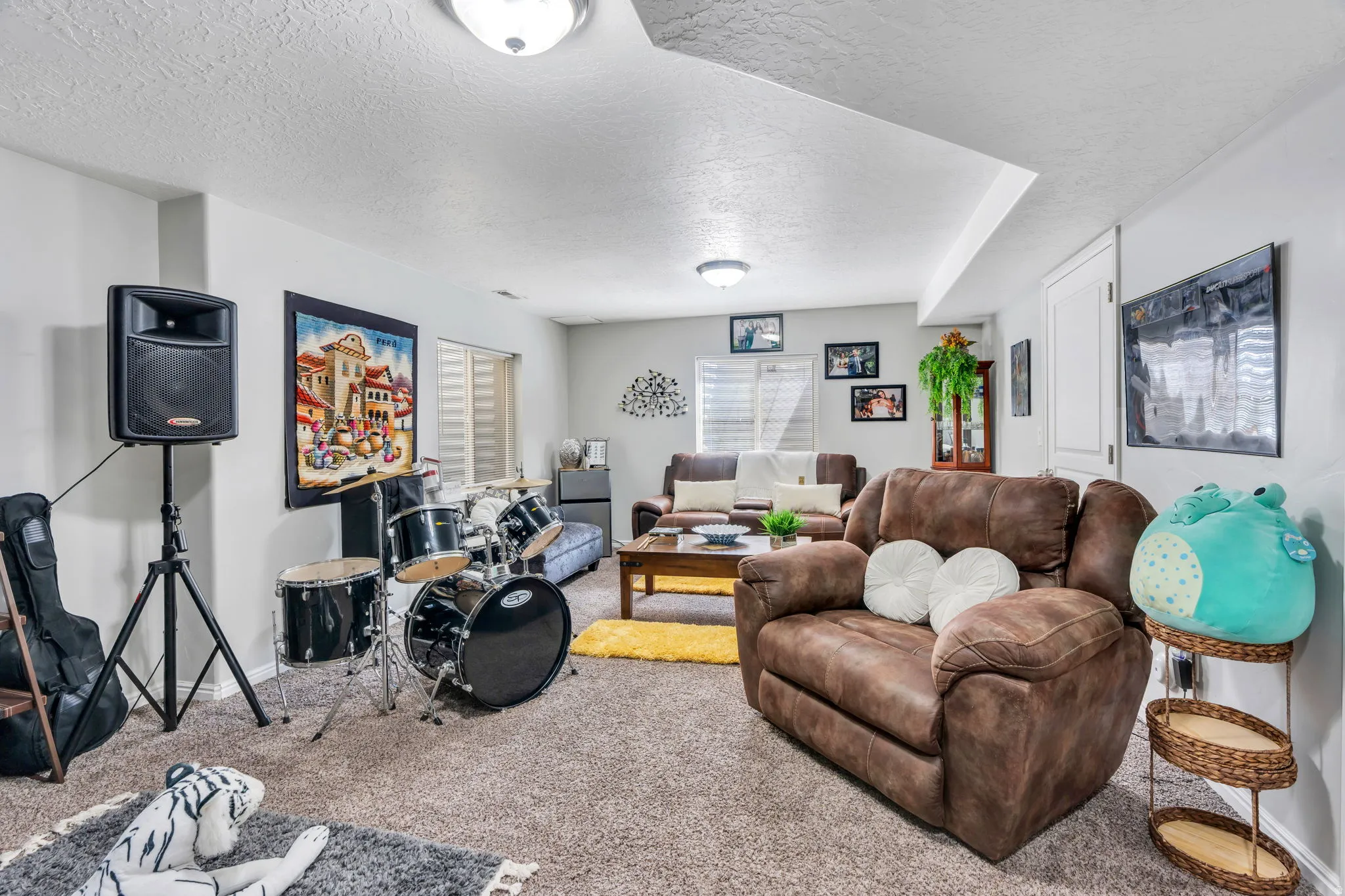 Recessed ceiling lighting, textured ceiling, light gray walls, white trim, and carpeted flooring