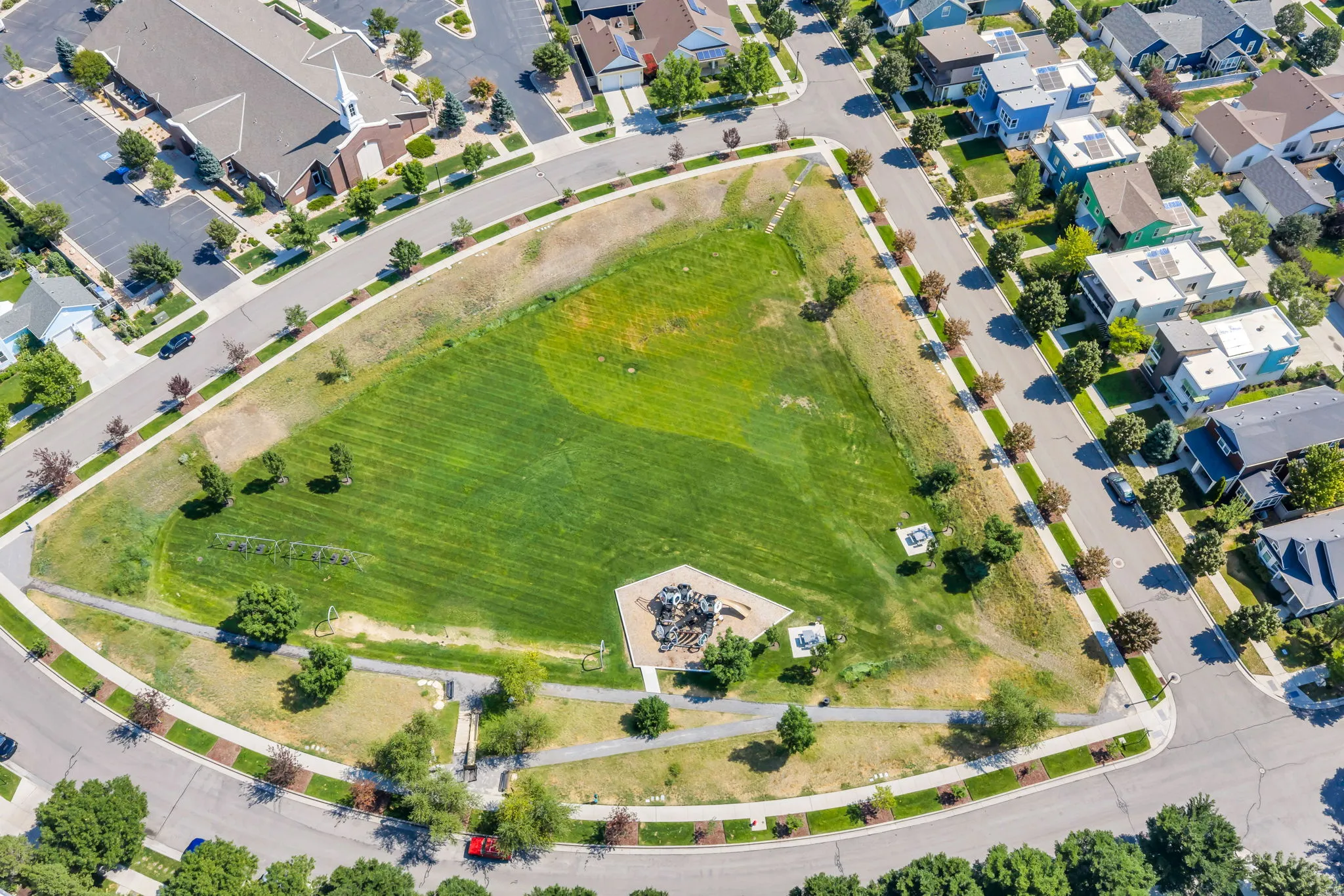 Expansive green space with walking paths and mature trees
