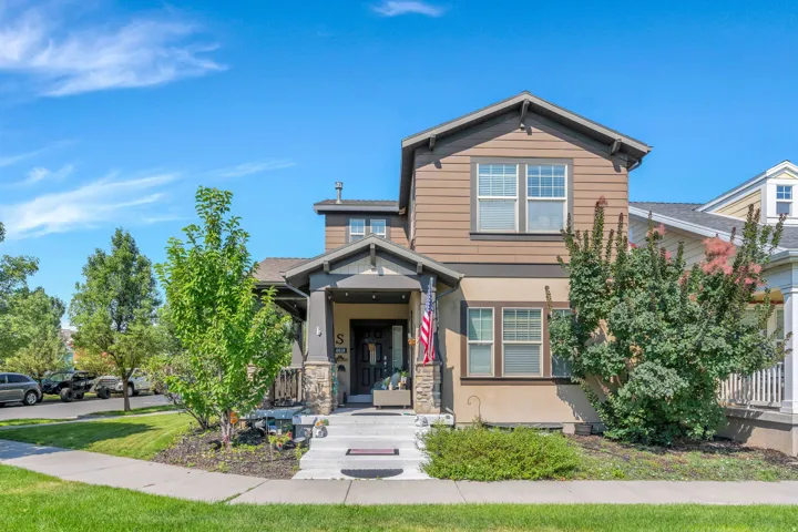Craftsman-style exterior with a covered porch, stone column accents, and shake siding