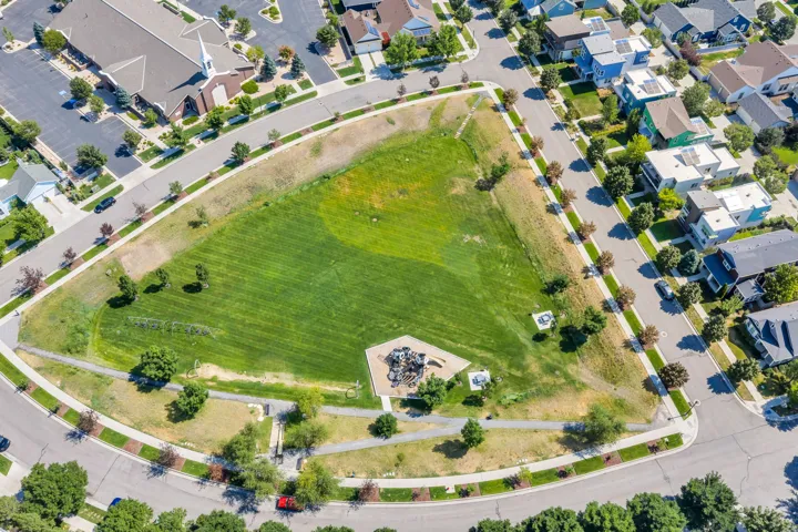 Expansive green space with walking paths and mature trees