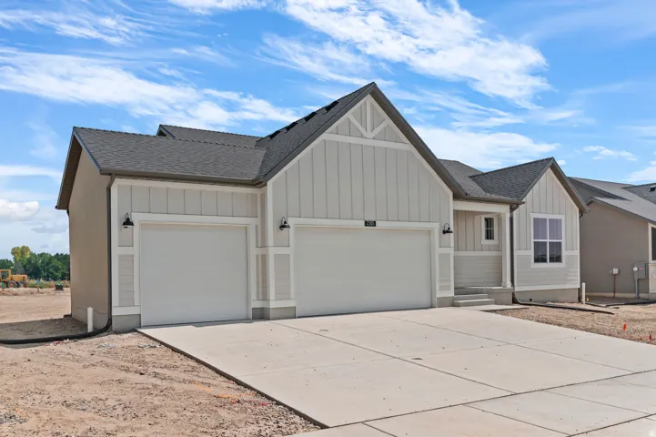 Contemporary exterior with board and batten siding, a two-car garage, a covered front porch, and a concrete driveway