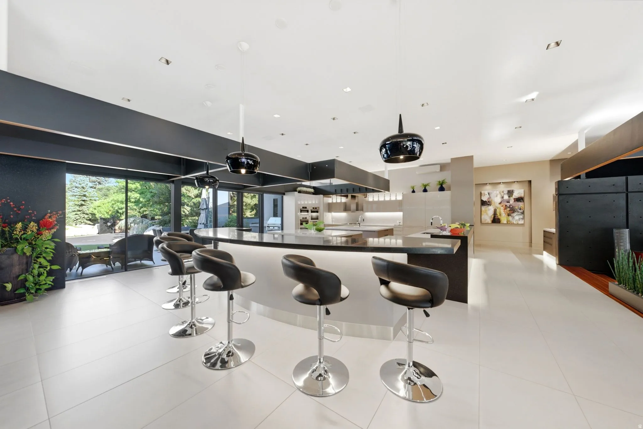 Expansive white tile flooring leading to a built-in kitchen island with integrated lighting