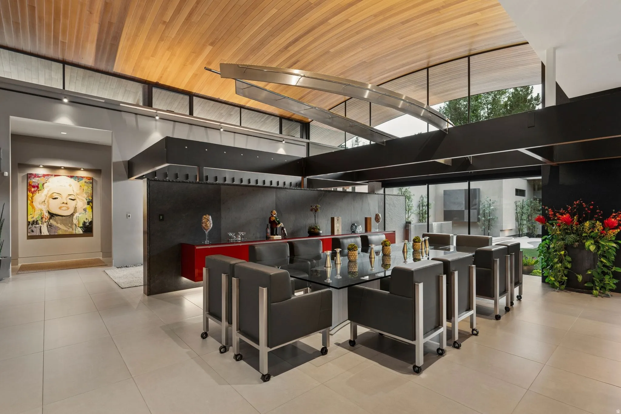 Vaulted wood-paneled ceiling, expansive glass wall, recessed lighting, and light-toned tile flooring